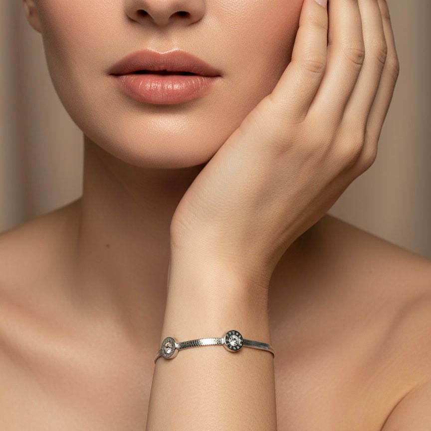 Woman wearing a silver bracelet on a neutral background